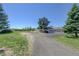 Spacious land with a well-maintained driveway leading up to the house and garage at 45321 Summit Rd, Parker, CO 80138
