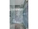 Modern shower with gray tile, glass door, and rainfall shower head at 45321 Summit Rd, Parker, CO 80138