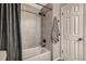 Clean bathroom featuring a shower with gray tile and updated fixtures at 2974 S Parker Ct, Aurora, CO 80014