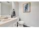 Powder bathroom features a white vanity and toilet, along with modern decor at 2974 S Parker Ct, Aurora, CO 80014