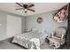 Inviting bedroom showcasing a ceiling fan, toy storage, and comfortable finishes at 2974 S Parker Ct, Aurora, CO 80014