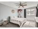 Charming bedroom featuring a ceiling fan, large window, and gray finishes at 2974 S Parker Ct, Aurora, CO 80014