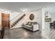 Open living room features a staircase, vinyl floors, access to the kitchen and front door at 2974 S Parker Ct, Aurora, CO 80014