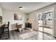 Cozy living room features a fireplace, sliding glass doors to the patio, and vinyl floors at 2974 S Parker Ct, Aurora, CO 80014