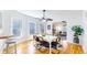 Sunlit dining room with a modern table, hardwood floors, and open access to the living room at 588 S Grant St, Denver, CO 80209