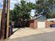 Detached brick garage with a paved driveway and alley access in the backyard at 588 S Grant St, Denver, CO 80209