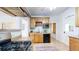 Bright kitchen with wooden cabinets, tile floors, and modern appliances at 588 S Grant St, Denver, CO 80209