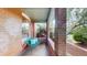Cozy covered porch with brick accents, comfortable seating, and a relaxing outdoor space at 588 S Grant St, Denver, CO 80209