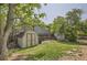 Well-maintained backyard featuring a storage shed, green grass, and privacy fencing at 16602 E Gunnison Pl, Aurora, CO 80017