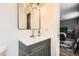 Updated bathroom features modern vanity and a stylish mirror and light fixture at 16602 E Gunnison Pl, Aurora, CO 80017