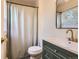 Bathroom featuring a shower with curtain, undermount sink with gold faucet, and tiled floors at 16602 E Gunnison Pl, Aurora, CO 80017
