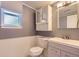 Charming bathroom features decorative wainscoting, vanity storage, and updated fixtures at 16602 E Gunnison Pl, Aurora, CO 80017