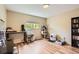 Bedroom featuring modern furnishings, lots of natural light, and wood laminate floors at 16602 E Gunnison Pl, Aurora, CO 80017