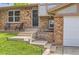 Close-up of the front porch showcasing the entrance, steps, and a small seating area with chairs at 16602 E Gunnison Pl, Aurora, CO 80017