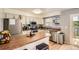 Well-lit kitchen with stainless steel appliances, wooden countertops, a center island, and a view to the backyard at 16602 E Gunnison Pl, Aurora, CO 80017