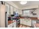 Bright kitchen featuring stainless steel appliances, wood countertops, ample storage, and modern fixtures at 16602 E Gunnison Pl, Aurora, CO 80017