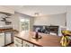 Kitchen with stainless steel dishwasher, island and view of the living room and fireplace at 16602 E Gunnison Pl, Aurora, CO 80017