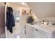 Functional laundry room with washer, dryer, and ample storage space at 16602 E Gunnison Pl, Aurora, CO 80017