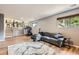 Open living room features wood laminate floors, large windows, and comfortable furnishings at 16602 E Gunnison Pl, Aurora, CO 80017