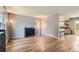 Open living room with wood-look flooring, stylish decor, and seamless flow into the kitchen area at 16602 E Gunnison Pl, Aurora, CO 80017