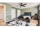 The main bedroom features a ceiling fan, ample closet space, and lots of natural light at 16602 E Gunnison Pl, Aurora, CO 80017