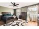 Stylish main bedroom featuring a ceiling fan, ample closet space, and lots of natural light at 16602 E Gunnison Pl, Aurora, CO 80017