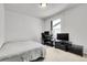 Small bedroom with a simple design, desk, and carpet at 4358 S Nepal Ct, Centennial, CO 80015