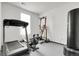 Home gym featuring modern fitness equipment, including a treadmill, weight machine, and heavy bag at 4358 S Nepal Ct, Centennial, CO 80015