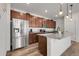 Modern kitchen with stainless steel refrigerator, wood cabinets, granite countertops and a kitchen island at 4358 S Nepal Ct, Centennial, CO 80015
