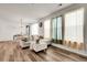 Bright and airy living room featuring wood floors, neutral-colored furniture, and large windows with curtains at 4358 S Nepal Ct, Centennial, CO 80015