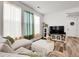 Comfortable living room with soft lighting, wood flooring, and stylish decor and green accents at 4358 S Nepal Ct, Centennial, CO 80015