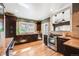 Well-lit kitchen features dark cabinetry, stainless steel appliances, and tile backsplash at 1464 S Grant St, Denver, CO 80210