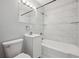 Bright, tiled bathroom with a white vanity and updated fixtures at 1934 Macon St, Aurora, CO 80010