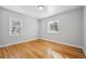 A bright bedroom with hardwood floors and two windows at 1934 Macon St, Aurora, CO 80010