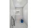 A clean laundry area has a window for light and a blue bucket at 1934 Macon St, Aurora, CO 80010