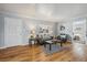 Inviting living room with stylish furniture, warm wood floors, and abundant natural light at 1934 Macon St, Aurora, CO 80010