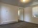 Simple bedroom with gray carpeting, mirrored closet doors, and window at 2696 S Jersey St, Denver, CO 80222