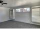 Bright bedroom with gray carpeting, built-in shelving, and window at 2696 S Jersey St, Denver, CO 80222