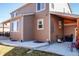 Backyard featuring a brown home exterior and a concrete patio; great for outdoor living at 30 Stewart Way, Erie, CO 80516