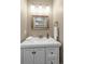 Bathroom showcasing a stylish vanity with a white countertop and modern fixtures, plus a decorative mirror at 30 Stewart Way, Erie, CO 80516