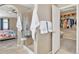 Bathroom featuring a glass shower, tile flooring, and walk-in closet at 30 Stewart Way, Erie, CO 80516