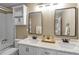 Bathroom featuring a double vanity, shower, and cabinet for extra storage at 30 Stewart Way, Erie, CO 80516