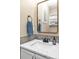 Bathroom featuring a white vanity with stone countertops, modern fixtures, and neutral gray accents at 30 Stewart Way, Erie, CO 80516