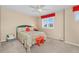 Bedroom with a floral bedspread, and a window with shutters and red valance at 30 Stewart Way, Erie, CO 80516