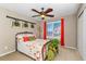 Bedroom with a wrought iron bed, window with shutters, and red curtains at 30 Stewart Way, Erie, CO 80516