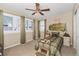 A bedroom with a ceiling fan, carpet flooring, and a mural on the wall at 30 Stewart Way, Erie, CO 80516