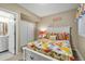 Bright bedroom featuring a white bed frame, colorful bedding, and access to an ensuite bathroom at 30 Stewart Way, Erie, CO 80516