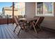 Cozy deck features a round wooden table with chairs, perfect for outdoor dining at 30 Stewart Way, Erie, CO 80516