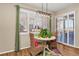 Sunny dining area with shutters, stylish light fixture, and sliding glass doors to the patio at 30 Stewart Way, Erie, CO 80516