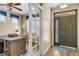 Inviting foyer with a decorative front door, glass paneled sidelight, hardwood floors, and an adjacent office at 30 Stewart Way, Erie, CO 80516